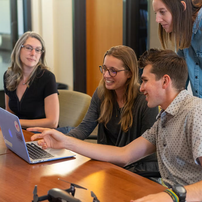 Four employees answering questions from an employee engagement software