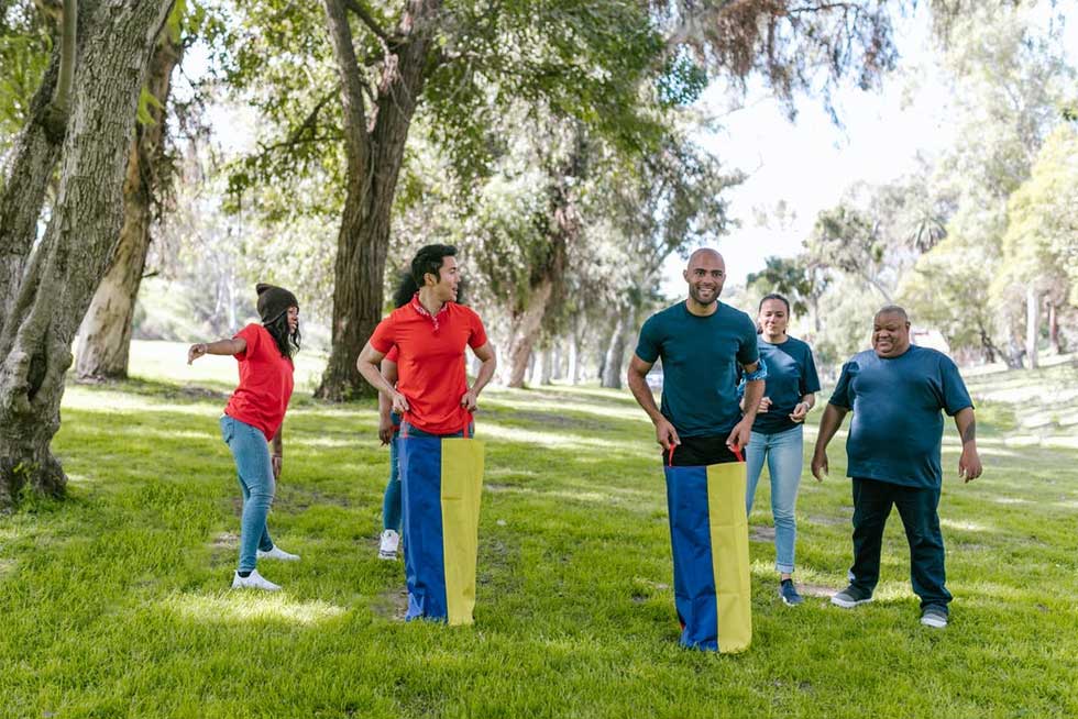 Team members playing the sack race