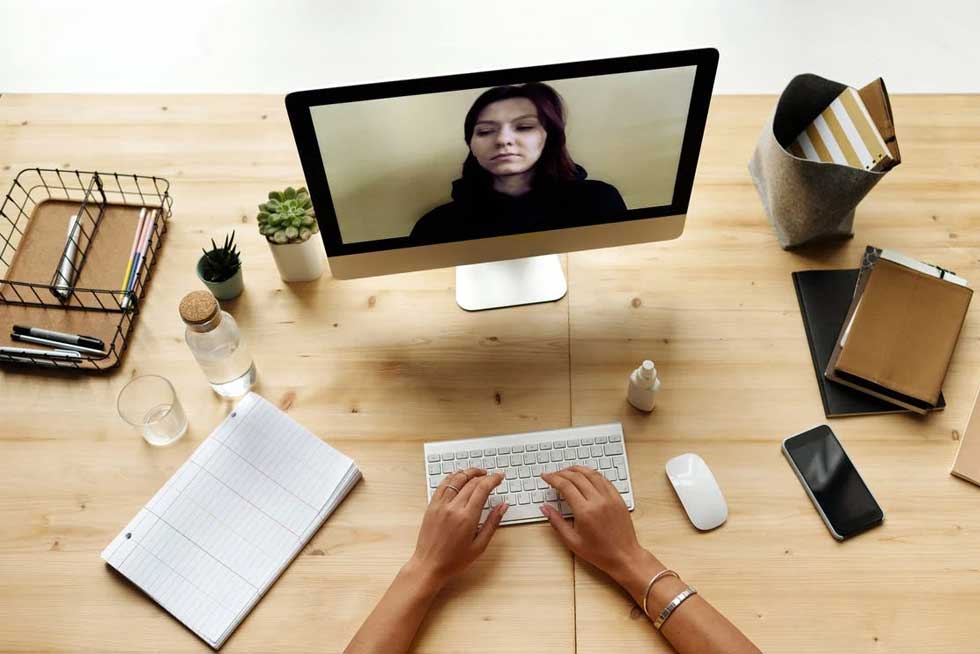 An employee discussing training topics to a remote worker