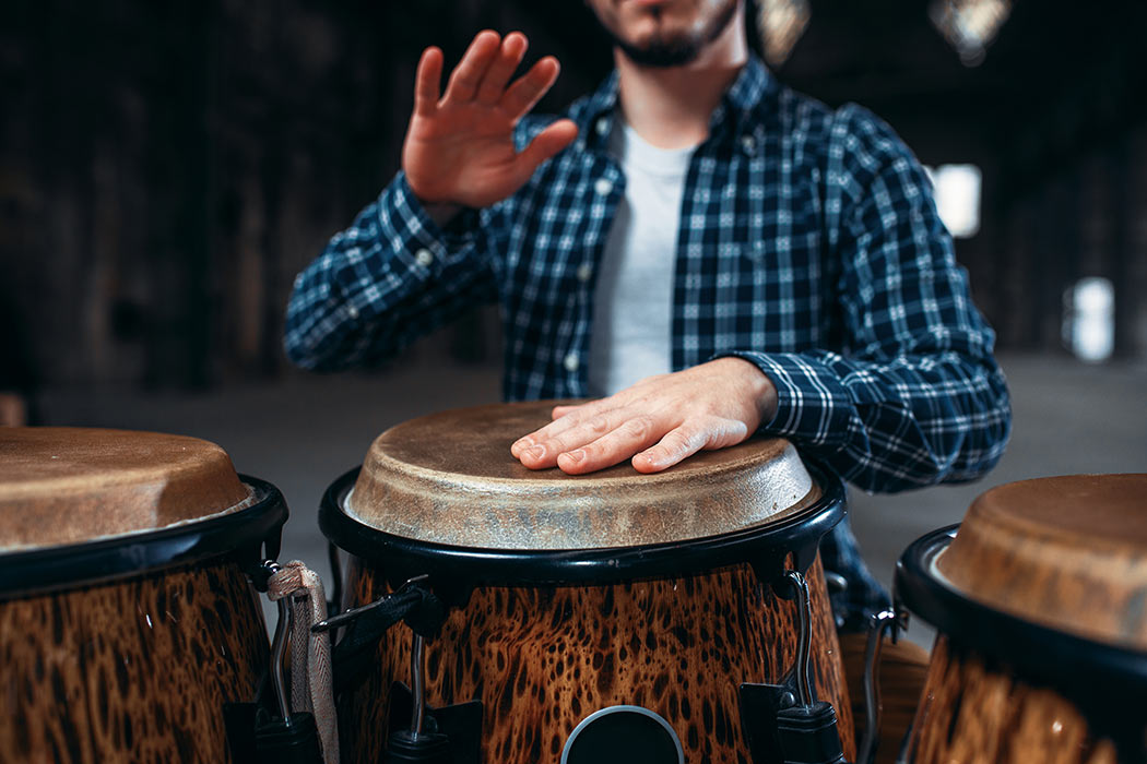 a person playing a drum for team building activity