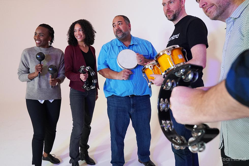 A group of peple playing instruments for team building activity Team Beats by Teamland