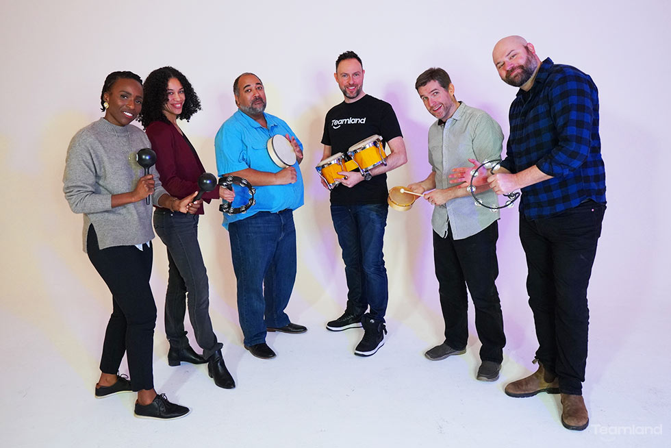 A group of peple playing instruments for team building activity Team Beats by Teamland