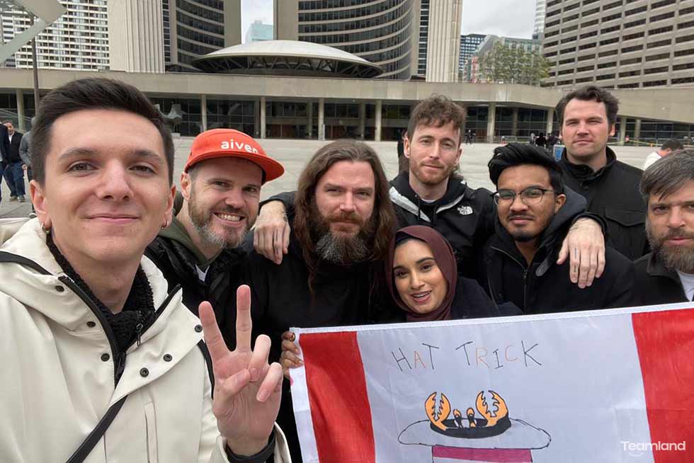 A group of people participating in Teamland Amazing Race team building activity with a selfie in a city