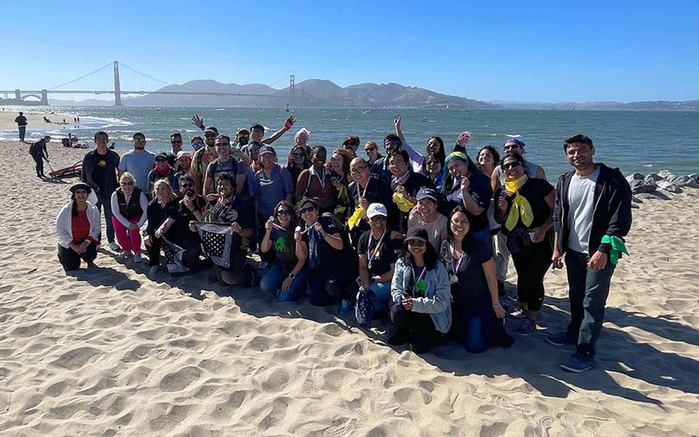 A group of people participating in a Teamland Amazing Race team building activity outdoors in USA