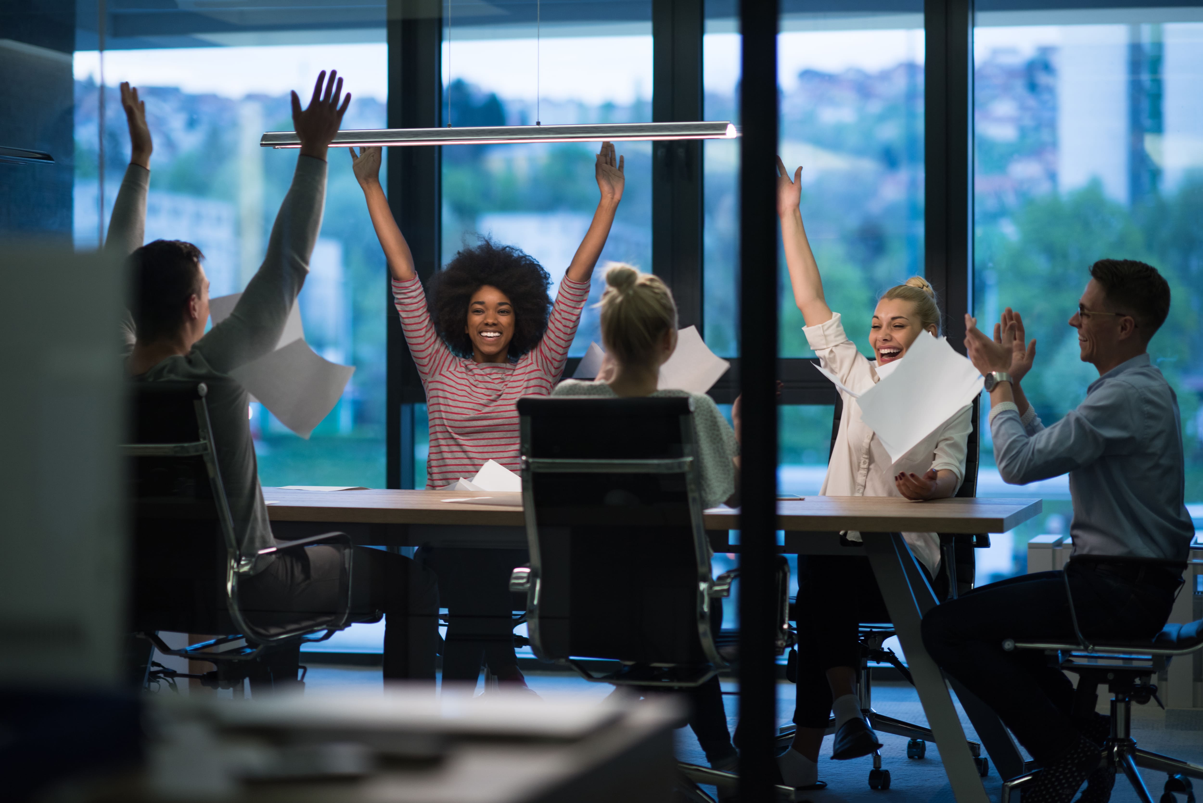 Young business people throwing documents