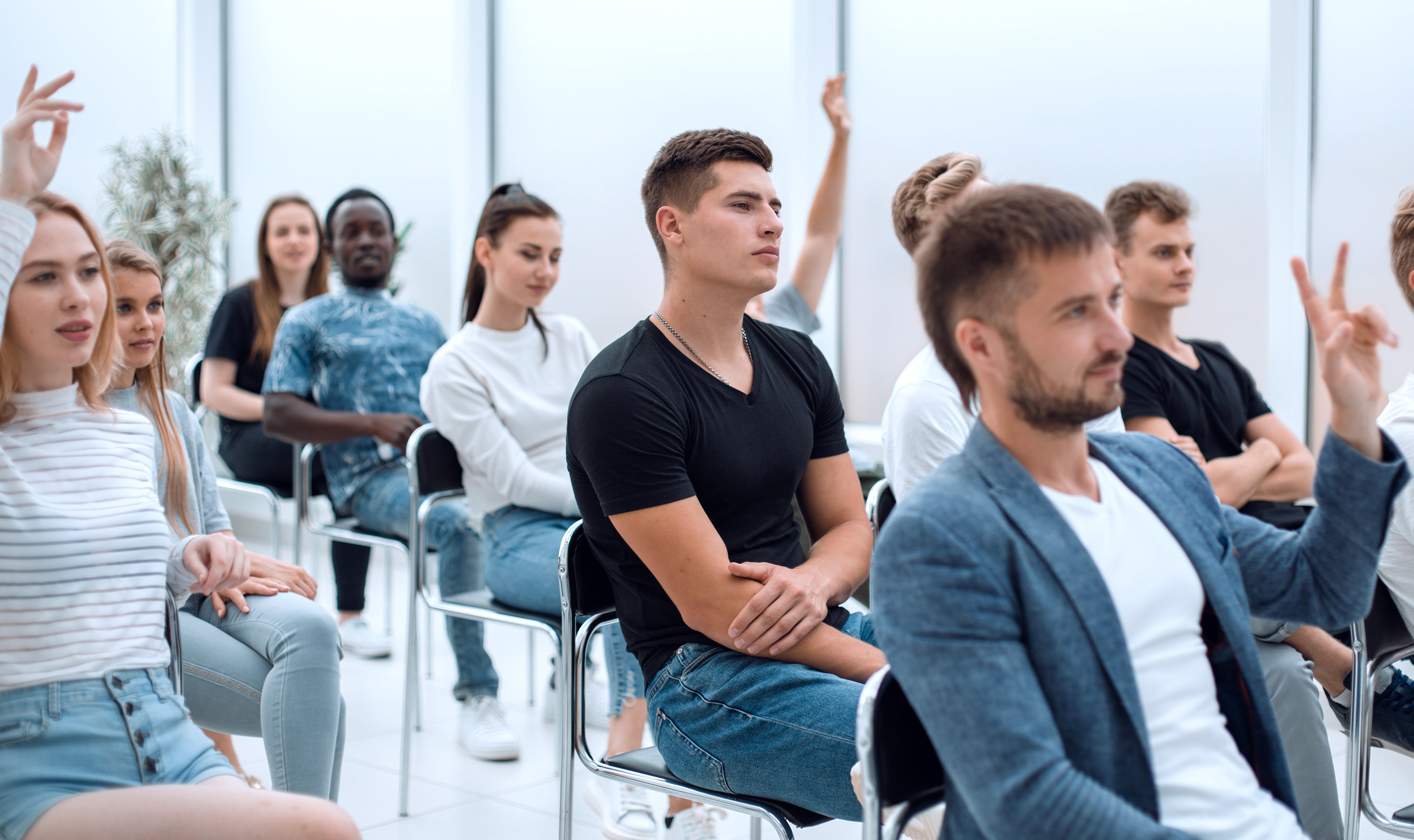 Casual young people sitting at the seminar