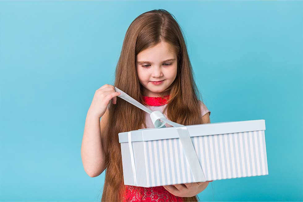 A child opening a present from Teamland