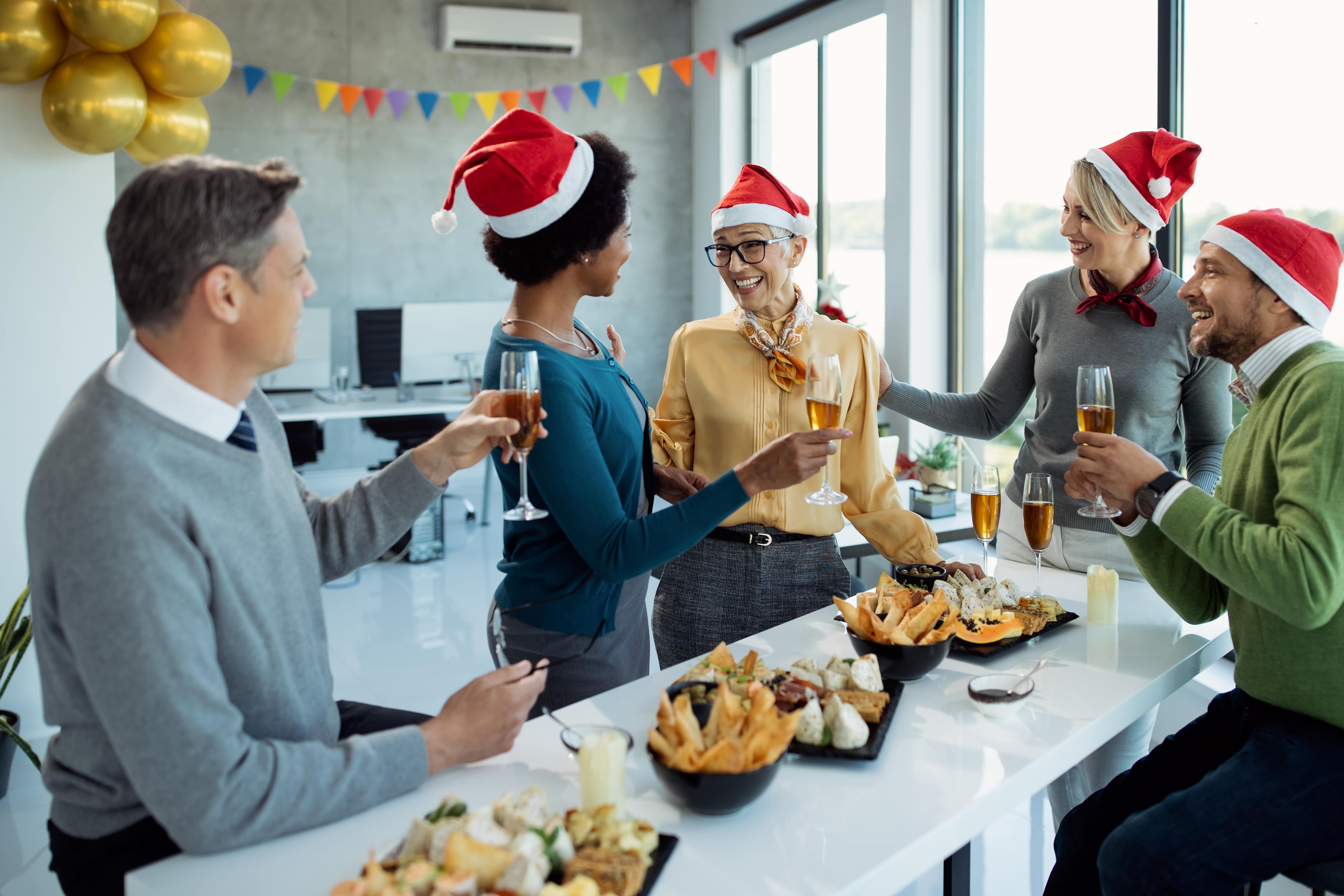Business people talking during their office Christmas event