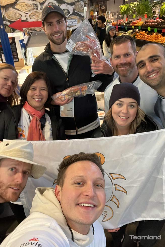 A group of people participating in Teamland Amazing Race team building activity with a selfie in a store