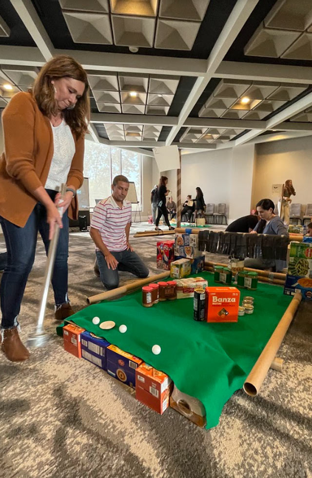 Woman Playing Mini Golf Team Building Course